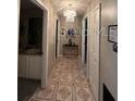 Bright hallway with tile flooring and access to other rooms at 517 Cardinal Dr, Kissimmee, FL 34759