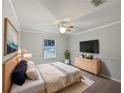Bright bedroom with a large bed, dresser, and plenty of natural light at 5803 Sw 107Th St, Ocala, FL 34476