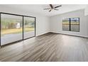 Spacious living area with large sliding glass doors and wood-look floors at 6117 Oakcrest Cir, Orlando, FL 32808