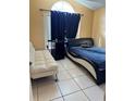 Bedroom with a queen-size bed, a sofa bed and large window at 6868 Westlake Blvd, Orlando, FL 32810