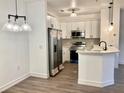 Modern white kitchen with stainless steel appliances at 8124 Claire Ann Dr # 202, Orlando, FL 32825