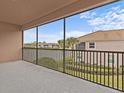 Screened balcony overlooking a lake and community at 8307 Fontera Dr, Davenport, FL 33896