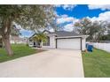 White house with blue door, landscaping, and driveway at 245 Heronwood Cir, Deltona, FL 32725