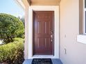 Brown front door and welcome mat at 112 Augustus Pt, Sanford, FL 32773