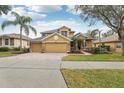 Two-story house with a three-car garage and brick driveway at 1395 Legendary Blvd, Clermont, FL 34711