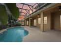 Inviting pool area with covered patio and lighting at 1395 Legendary Blvd, Clermont, FL 34711