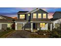 Charming two-story home with a two-car garage, well-maintained landscaping, and inviting front porch at 14789 Milfoil Ave, Orlando, FL 32827