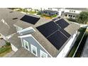 Aerial view of house rooftop with solar panels installed for energy efficiency and modern living at 14789 Milfoil Ave, Orlando, FL 32827