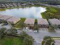 An aerial view of the property highlights its location on a large lake and a well-maintained neighborhood at 1604 Scarlet Oak Loop # B, Winter Garden, FL 34787