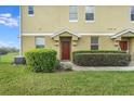 A charming front entrance shows the front door with well-maintained landscaping and healthy green grass at 1604 Scarlet Oak Loop # B, Winter Garden, FL 34787