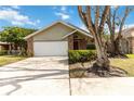 House exterior featuring a two-car garage and landscaping at 3131 Ash Park Loop, Winter Park, FL 32792