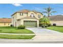 Two-story house, green garage door, and a well-maintained lawn at 3235 Abiaka Dr, Kissimmee, FL 34743