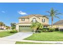 Two-story house featuring a green garage door and lush lawn at 3235 Abiaka Dr, Kissimmee, FL 34743