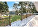 Deck overlooking a lake and backyard with white fence at 3645 Mirror Lake Dr, Apopka, FL 32703