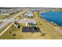 An aerial view shows the playground, community pool, cabana, and lake at 3801 Giorgio Dr, Winter Haven, FL 33884