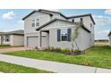 Stylish two-story home with a two-car garage, manicured landscaping, and a welcoming facade at 3833 Giorgio Dr, Winter Haven, FL 33884