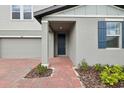 Close-up of the home's entrance showcasing a brick walkway and a covered entryway at 3833 Giorgio Dr, Winter Haven, FL 33884