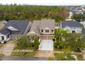 Aerial view of a two-story house with well maintained landscaping and a two-car garage at 4220 Cleary Way, Orlando, FL 32828