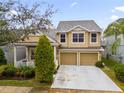 Charming two-story home with manicured landscaping, two-car garage, and welcoming front porch at 4220 Cleary Way, Orlando, FL 32828