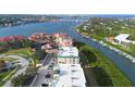 A breathtaking aerial view of a waterfront complex with lush greenery, offering stunning views of the river and a vibrant landscape at 432 Bouchelle Dr # 102, New Smyrna Beach, FL 32169