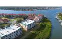 An aerial view of a waterfront condominium complex with stunning views of the river and surrounding coastal landscape at 432 Bouchelle Dr # 102, New Smyrna Beach, FL 32169