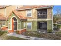 Two story condo building with Spanish tile roof and screened balcony at 445 Fountainhead Cir # 164, Kissimmee, FL 34741