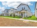 Street view of stylish two-story homes featuring colorful exteriors, charming front porches, and landscaped yards at 5003 Railroad Vine Aly, Winter Garden, FL 34787