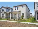 Well-maintained two-story home, light exterior, and a small front garden at 5087 Railroad Vine Aly, Winter Garden, FL 34787