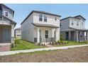 Two-story home with a front porch, complemented by tidy landscaping and sidewalks at 5087 Railroad Vine Aly, Winter Garden, FL 34787
