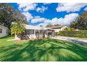 Mid-century modern home with carport and well-manicured lawn at 5416 Parkway Dr, Belle Isle, FL 32809