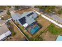 Home with a screened pool and solar panels on the roof at 5535 Long Lake Dr, Orlando, FL 32810