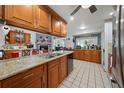 Spacious kitchen featuring granite countertops and wood cabinets at 5535 Long Lake Dr, Orlando, FL 32810