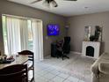 Cozy living room features bright, natural lighting and tile flooring at 5885 Dahlia Dr # 31/116, Orlando, FL 32807