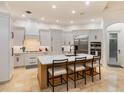 Modern kitchen, featuring a large island, stainless steel appliances, and white cabinetry at 6874 Valhalla Way, Windermere, FL 34786