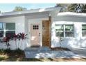 Renovated entryway with pink door and wood paneling at 7007 Seminole Dr, Belle Isle, FL 32812