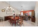 Dining room with wood table and chairs, view to living room at 7025 Hiawassee Oak Dr, Orlando, FL 32818