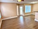 Bright living room featuring wood-look flooring and a ceiling fan for comfortable living at 731 Sugar Bay Way # 103, Lake Mary, FL 32746