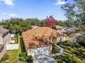 Single-Gathering home with a brown roof and a large backyard in a residential area at 7895 Saint Giles Pl, Orlando, FL 32835