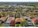 Residential neighborhood with houses featuring various roof styles and landscaping at 7895 Saint Giles Pl, Orlando, FL 32835