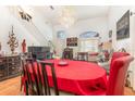 Bright living and dining area featuring high ceilings, hardwood floors and elegant chandelier at 7909 Chartreux Ln, Maitland, FL 32751