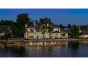 Luxury waterfront home with expansive lake views at dusk at 9122 Bay Point Dr, Orlando, FL 32819