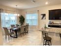 Bright dining area with a wood table and six chairs at 1012 Anchorage Street, Leesburg, FL 34748