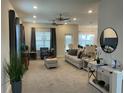 Spacious living room with beige carpet and comfy furniture at 1012 Anchorage Street, Leesburg, FL 34748