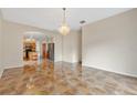 Spacious dining room with tile floors and a crystal chandelier at 1122 Hacienda Cir, Kissimmee, FL 34741