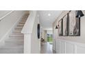 Modern carpeted staircase with neutral tones and open floorplan at 1540 Lumbar Ave, Davenport, FL 33896