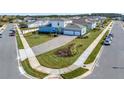 Property's aerial view showing house, driveway, landscaping, and neighborhood context at 15913 Winding Bluff Dr, Montverde, FL 34756