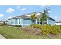 Light blue house with landscaping, showcasing a side view at 15913 Winding Bluff Dr, Montverde, FL 34756