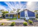 Bright blue home with stone accents and a welcoming yellow door at 1720 Overlook Rd, Longwood, FL 32750