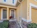 Front entrance of townhome with walkway and landscaping at 17454 Chateau Pine Way, Clermont, FL 34711