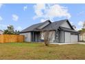 Charming gray house with a fenced backyard and spacious lawn at 2201 Kentucky Derby Dr, Orlando, FL 32825